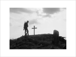 A British soldier stands besides the grave of a comrade near Pilckem during the Third Battle of Ypres, 22 August 1917.