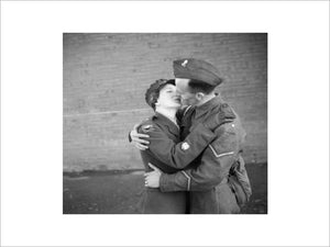 Staff Sergeant-Major Twist of the ATS embraces and kisses her husband, Lance-Bombardier Twist during a special photo-shoot at Army Headquarters in Northern Ireland, 22 October 1941.