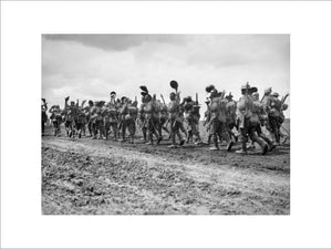 Ernest Brooks: Men of the Wiltshire Regiment waving their helmets as they march along the Acheux road to the trenches.