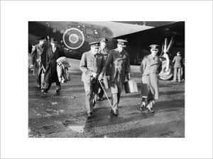 The Prime Minister, Winston Churchill in RAF uniform, accompanied by Air Chief Marshal Sir Charles Portal, Chief of the Air Staff, leaving Consolidated Liberator "Commando" of No. 24 Squadron RAF at Lyneham, Wiltshire, on their return from the Casablanca