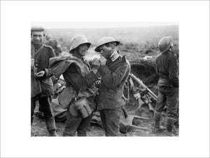 British and German wounded at an advanced dressing station near Epehy share a cigarette, 18 September 1918.