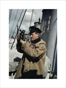 A Royal Navy officer using a sextant aboard a destroyer on convoy protection duties, 1942.