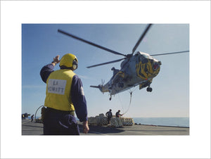 A Westland Sea King of No. 814 Naval Air Squadron picking up stores from HMS INVINCIBLE, 1997.