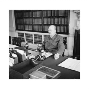 Winston Churchill makes a radio address from his desk at 10 Downing Street, wearing his 'siren suit', June 1942.