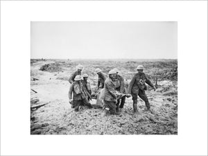 A team of stretcher bearers struggle through deep mud to carry a wounded man to safety near Boesinghe on 1 August 1917 during the Third Battle of Ypres.