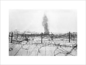 A shell bursting amongst the barbed wire entanglements on the battlefield at Beaumont Hamel, December 1916.