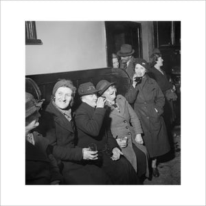 A group of women enjoy a drink and share a joke at the Wynnstay Arms, Ruabon, Benbighshire, Wales, 1944.