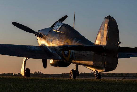 Hawker Hurricane sits at the Duxford Airfield during sunrise