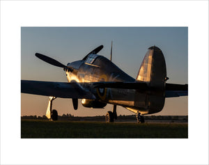 Hawker Hurricane sits at the Duxford Airfield during sunrise