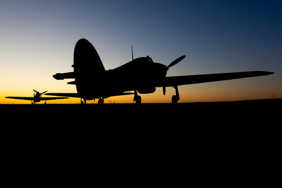 Two Hawker Hurricanes at the Duxford Airfield during sunrise