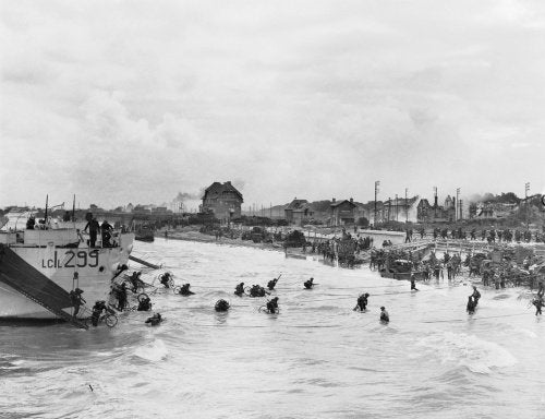 Follow-up waves of the 9th Canadian Infantry Brigade disembarking with bicycles from landing craft onto 'Nan White' sector of Juno Beach at Bernieres-sur-Mer, 6 June 1944.