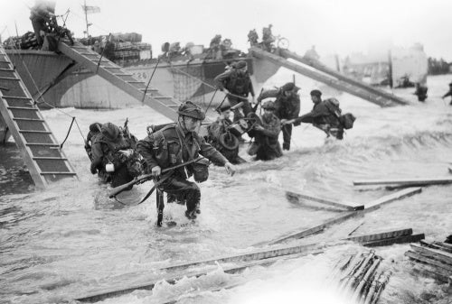 Royal Marine Commandos of headquarters, 4th Special Service Brigade, making their way onto the 'Nan Red' sector of Juno Beach at St Aubin-sur-Mer, on the morning of 6 June 1944.