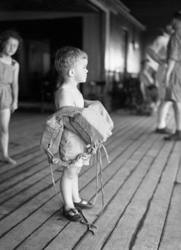 A small child on deck with his life belt on board SS EMPRESS OF AUSTRALIA, August 1941.