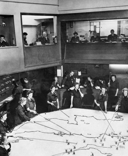 The Operations Room at RAF Fighter Command's No. 10 Group Headquarters, Rudloe Manor (RAF Box), Wiltshire, showing WAAF plotters and duty officers at work, 1943.