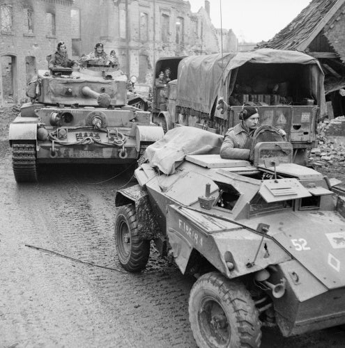 A Humber scout car and Comet tank of 11th Armoured Division in a devastated German town, 30 March 1945.