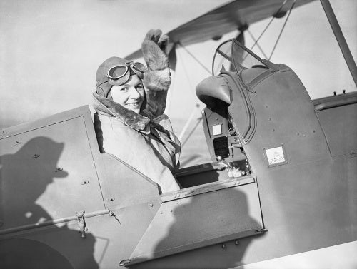 Pauline Gower, Commandant of the Air Transport Auxiliary Women's Section, waving from the cockpit of a de Havilland Tiger Moth at Hatfield, Hertfordshire, prior to a delivery flight, 10 January 1940.