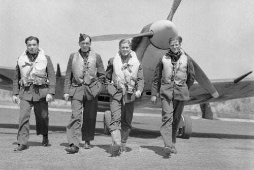 Pilots of No. 611 Squadron walk away from a Supermarine Spitfire Mk V at Hornchurch after a daylight sweep over France, 7 July 1941.