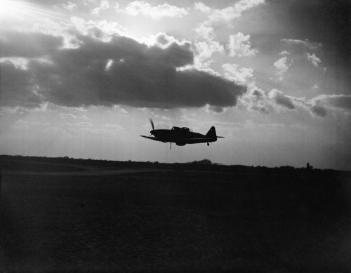 Boulton Paul Defiant Mk I night-fighter of No. 264 Squadron RAF, silhouetted against the clouds during a low-level pass over its base at Biggin Hill, Kent, April 1941.