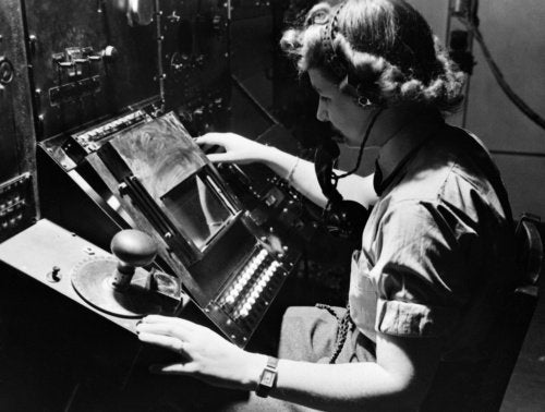 WAAF radar operator Denise Miley plotting aircraft on a cathode ray tube in the Receiver Room at Bawdsey 'Chain Home' station, May 1945.
