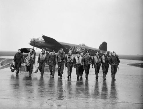 Aircrew of No. 106 Squadron photographed in front of a Lancaster at Syerston, Nottinghamshire, on the morning after the raids on Genoa, 22-23 October 1942.