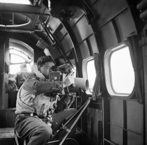 A crewman on board an RAF Coastal Command Lockheed Hudson of No. 269 Squadron, using an F.24 camera during an ice patrol from Kaldadarnes in Iceland, 5 May 1942.