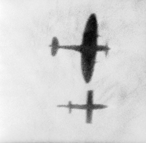 A Supermarine Spitfire flying alongside a V-1 flying bomb in an attempt to disrupt the airflow over its wing and force it to crash, August 1944.