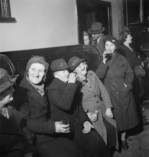 A group of women enjoy a drink and share a joke at the Wynnstay Arms, Ruabon, Benbighshire, Wales, 1944.