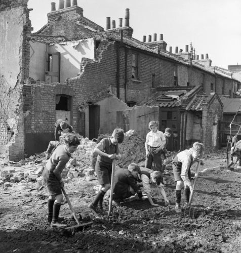 Boys creating an allotment on a bomb site in London during 1942.