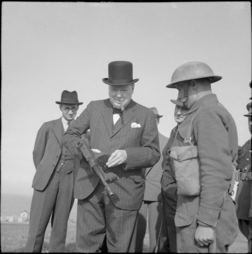 Winston Churchill holds a 'Tommy gun' during an inspection of invasion defences near Hartlepool, 31 July 1940.