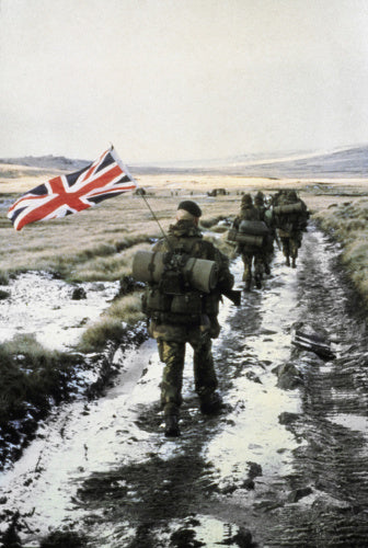 45 Royal Marine Commando marches towards Port Stanley during the Falklands War, 1982. Marine Peter Robinson carrys the Union Flag on his pack.