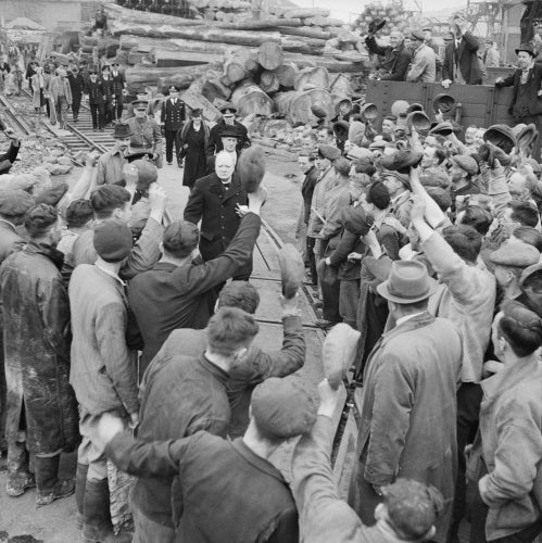 Winston Churchill is cheered by workers during a visit to bomb-damaged Plymouth, 2 May 1941.