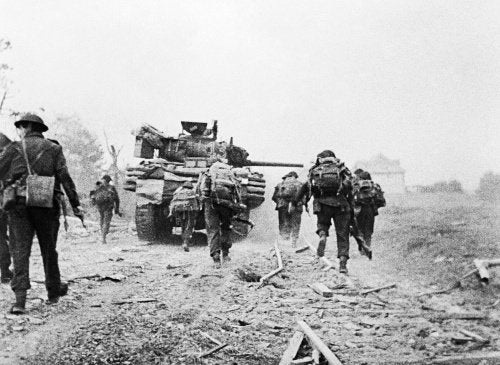Sherman DD tanks of 'B' Squadron, 13th/18th Royal Hussars support men of No. 4 Army Commando advancing towards Ouistreham on D-Day, 6 June 1944.