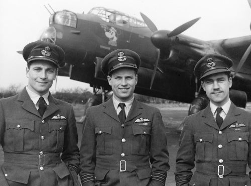 Wing Commander Guy Gibson (centre), CO of No. 106 Squadron RAF, with his two Flight Commanders, Squadron Leader J H Searby (left) and Squadron Leader P Ward-Hunt, at Syerston, on the completion of Gibson's tour of operations, March 1943.
