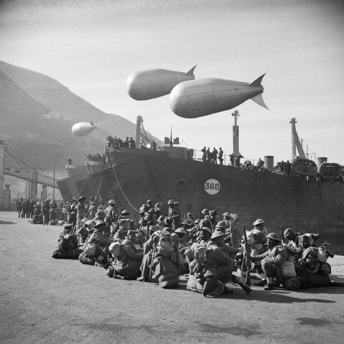 South African troops of 1991 Swaziland Smoke Company wait to board landing craft at Castellammare before sailing for Anzio, January 1944. The unit was responsible for creating smokescreens over the invasion area.