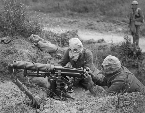 A Vickers machine gun team wearing PH Type anti-gas helmets in action near Ovillers during the Battle of the Somme, 1916.