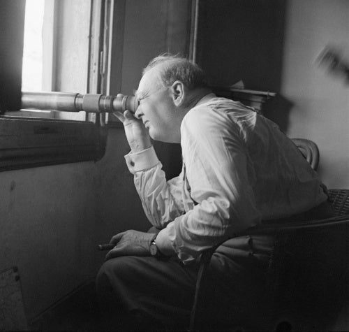 Winston Churchill uses a telescope to watch an assault against enemy positions north of Florence, from the observation post of a battery of the 66th (Lowland) Medium Regiment, Royal Artillery, 20 August 1944.