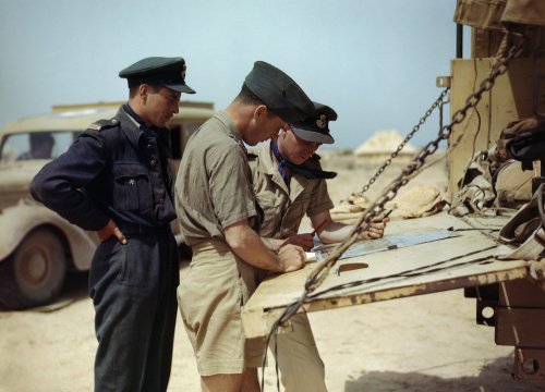 Spitfire pilots of No. 417 Squadron, Royal Canadian Air Force, planning another operation from their airfield at Goubrine in Tunisia, April 1943.