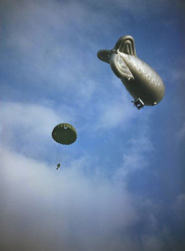 A paratrooper drops from a static balloon during training, 2 October 1942.