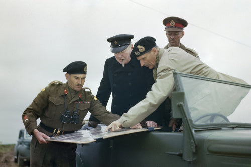 General Sir Bernard Montgomery shows Winston Churchill the battle situation on a map held by the Commander of the 2nd Canadian Division, General G G Symonds, during the Prime Minister's visit to Normandy, 22 July 1944.
