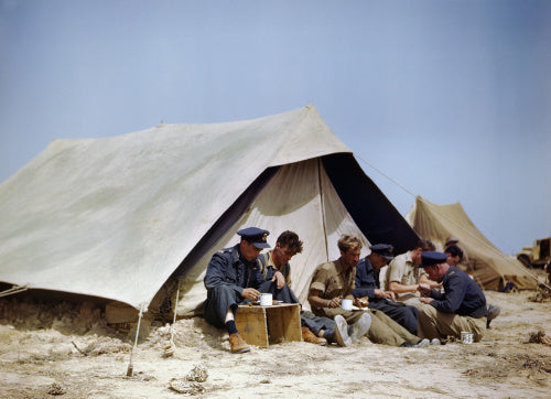 Spitfire pilots of No. 417 Squadron, Royal Canadian Air Force, having a meal outside a tent at Goubrine in Tunisia, April 1943.