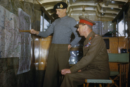 King George VI listens as Field Marshal Sir Bernard Montgomery outlines his future strategy at his mobile headquarters in Holland, 13 October 1944.