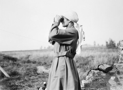 Miss Mairi Chisholm, one of the 'Women of Pervyse' looking through binoculars in Pervyse.