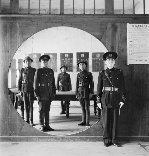 The Chinese Police Force; the Assistant Chief of Police and his staff grouped in a circular doorway at headquarters in Chengtu.