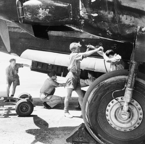 RAF armourers load a 250lb bomb into the bomb bay of a Wellington of No 38 Squadron, RAF Shallufa, Egypt, 1942