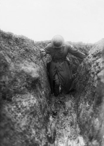 An Australian officer wading through the mud, Gird Trench, Gueudecourt.