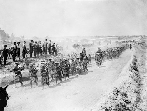 The Black Watch marching back along the Fricourt-Albert road headed by their pipers. Somme, August 1916.