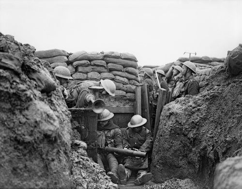 Soldiers of the Lancashire Fusiliers cleaning a Lewis Gun. On the left can be seen the gas alarm horn and wind vane. January 1917 near Ploegsteert.