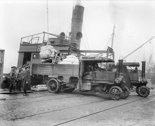 British troops unloading flour from a ship on to steam wagons. Calais, March 1917.