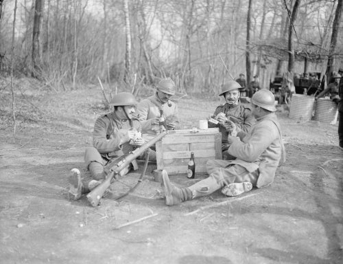 French and British soldiers playing cards together at Bernagousse, 16 March 1918.