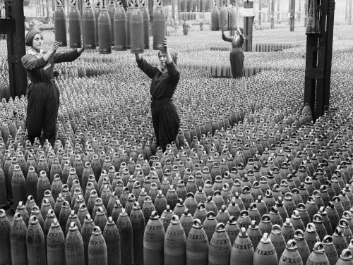 Female munitions workers guide 6 inch howitzer shells being lowered to the floor at the Chilwell ammunition factory in Nottinghamshire in July 1917.